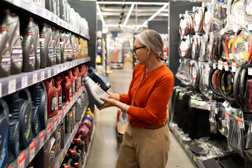 Woman shopping in a large home improvement store exploring various sections for kitchen, home,...