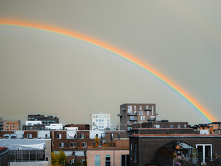 Rainbow over Ørestad in Copenhagen, Denmark, highlighting modern architecture and urban design...
