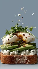 Gourmet toast topped with avocado, poached egg, and microgreens on a rustic plate. Elegant brunch concept in contemporary healthy cuisine