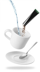 Instant coffee making. Combining granules from sachet and water in cup against white background