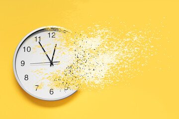 Time running out. Clock dissolving on orange background