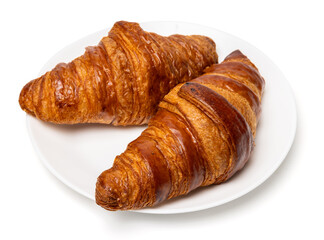 Two freshly baked classic delicious fresh organic croissants on white ceramic plate isolated on white background