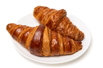 Two freshly baked classic delicious fresh organic croissants on white ceramic plate isolated on white background
