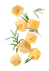 Cheese cubes and rosemary falling against white background