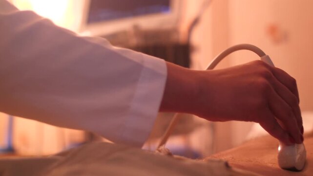Doctor making abdominal ultrasound examination on male patient in clinic.