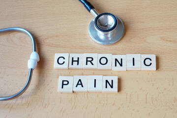 Medical Concepts. Chronic Pain. Word Written in Wooden Letters with a Stethoscope