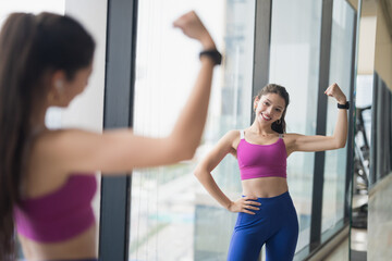 Healthy Young Hispanic Gen Z Woman in Sportswear Shaping Body for Confidence and Weight Loss at Gym.