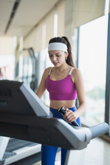Young Hispanic Gen Z Woman Running on Treadmill in Gym for Healthy Fitness Lifestyle