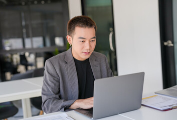 Fototapeta premium Business man working using laptop computer Hands typing keyboard. Professional investor working start up project. business planning in office. Technology business