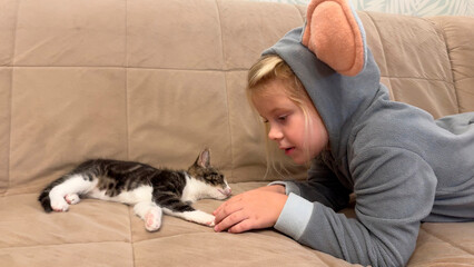 Girl playing with her cat