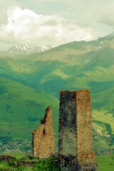 Ancient architecture and ruins against mountain background . Remains of a destroyed tower . North Ossetia-Alania , Russia