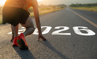 New year 2026 concept.Athlete poised at the starting line for the year 2026.Young man ready to run...