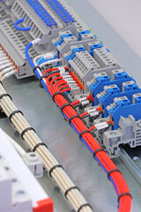 Electrical screw terminals for connecting wires in an electrical switchboard. Soft focus. Close-up.
