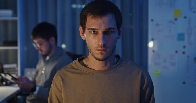 Team adult male freelance developer work late typing write prompt AI bot app program nomad terminal code at office night. Artificial intelligence dashboard, robotics, user interface, machine learning.