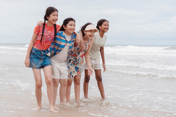 Happy group of diverse Asian and multicultural kids and daughters enjoying time together on the...