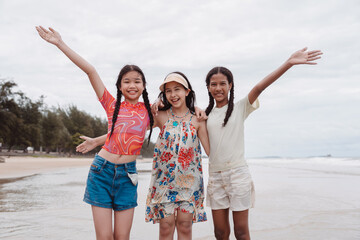 Friends enjoying the beach together Asian and multicultural kids smiling and playing by the sea, expressing childhood joy, freedom.