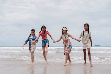 Asian and multicultural girls walking on the beach. friendship, freedom of childhood, togetherness, happiness, and summer vacation fun.