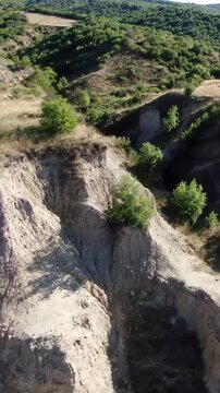 A Drone's Perspective of a Rugged, Sun-baked Canyon System with Visible Layers of Earth, Perfect for Geological or Environmental Themed Content
