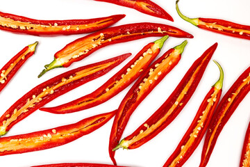 Sliced pods of red natural organic chili pepper on white background