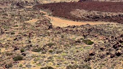 An aerial view of diverse volcanic terrain featuring unique rock formations and stunning natural...