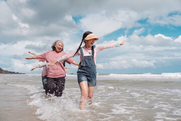 Asian family enjoying beach travel together, generations. retirement wellness, love, and joyful...