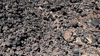 A stunning view showcasing the rugged lava rock terrain, featuring diverse rocky textures from a...