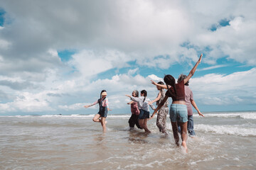 Asian family enjoying beach travel together, generations. retirement wellness, love, and joyful...