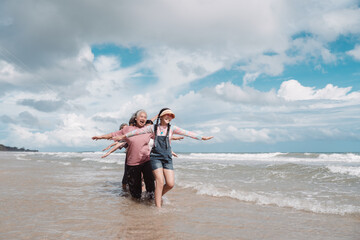 Asian family enjoying beach travel together, generations. retirement wellness, love, and joyful...
