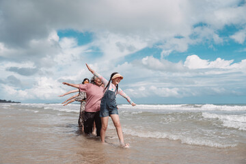 Asian family enjoying retirement wellness the beach, walking joyful moment balance, health,...