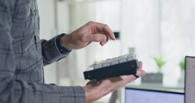 Closeup young adult male freelance developer typing write prompt AI bot app program nomad terminal with coding at office. Artificial intelligence dashboard, robotics, user interface, machine learning.