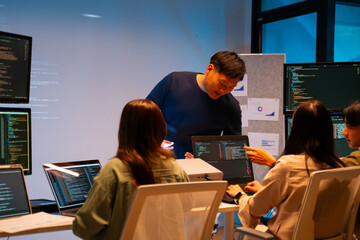 Asian software engineer or programmer team working late in development office,problem solving or...