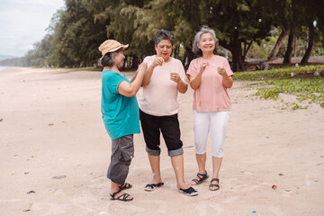Senior Asian females blowing bubbles on a beach, joyful retirement, freedom, living. Ideal for...