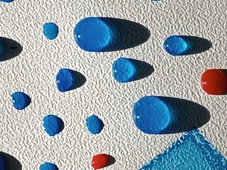 Vibrant blue water droplets on textured surface with shadows and a red accent