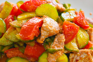 Spicy healthy homemade curry paste stir fry cucumber, tomato with pork. Healthy food. Asian meal.