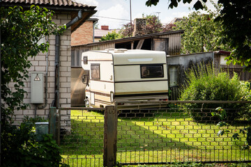 Retro Camper Van Parked in Residential Backyard on a Sunny Summer Day