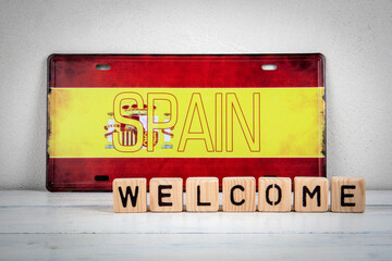Welcome to Spain Message with Wooden Blocks and Spanish Flag