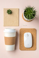 Flat Lay of Minimal Workspace with Coffee Cup, Mouse, Plants, and Eco Accessories on Pastel Background