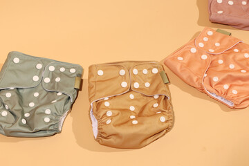 Modern Reusable Baby Cloth Diapers: Soft, Earth-toned Colors, Studio Shot.