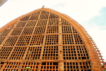 The building has a lot of wooden slats and is very old