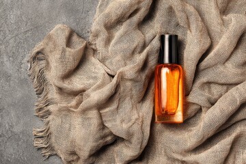 Amber glass bottle rests on a textured cloth