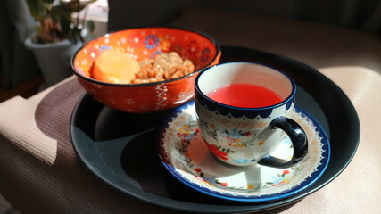 Morning Tray with Floral Tableware and Granola Bowl in Sunlit Interior