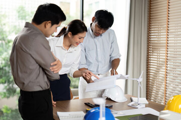 Sustainability Planning. Team reviewing eco-friendly project details.