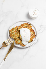 vegetarian zucchini fritters, light marble background
