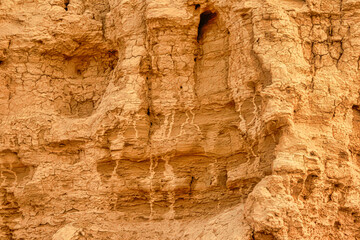 A rocky cliff with a lot of holes and cracks