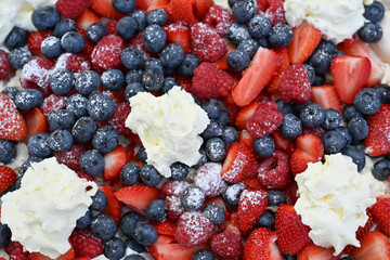 Delicious strawberry tart with blueberries, fresh raspberries and whipped cream, cheesecake, top view. High quality photo