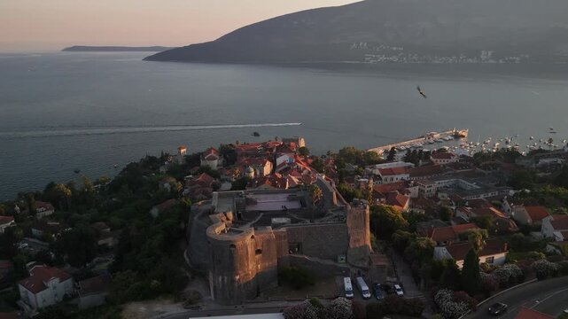 Golden sunset aerial orbits Kanli Kula fort event venue, Herceg Novi