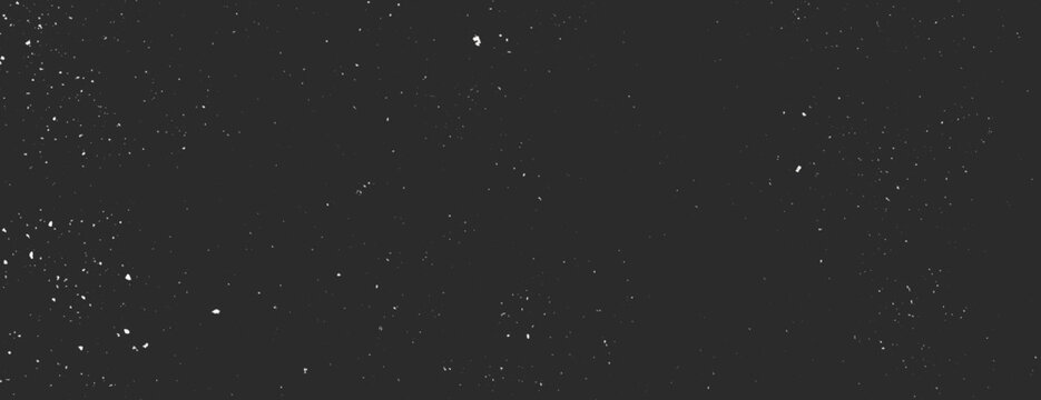 Dark black background with a starry texture. The black background features scattered white specks resembling stars in the night sky. Speckled wall texture background. Black background vector.