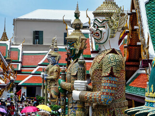 A group of statues of men with long arms