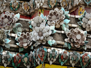 A wall covered in a variety of flowers, including white and blue ones