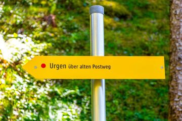 Yellow arrow location and hiking sign direction in Tyrol Austria.